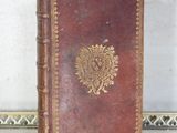 an old book sitting on top of a table next to a mirror