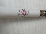 a pen with a floral design on it sitting on a table