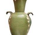 a green vase that is sitting on a white surface
