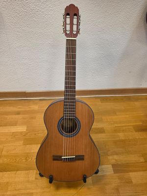 a guitar that is sitting on a stand on the floor