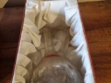 a empty glass bottle in a box on a table
