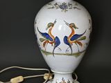 a white vase with a blue bird design on it