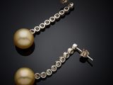 a pair of pearl and diamond earrings