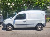 a small white van parked on the side of the road