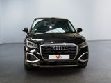 the front of a black audi suv parked in a showroom