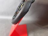 a red stand with a pair of shoes on top of it