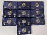 six packs of blue packets with a gold medallion on them