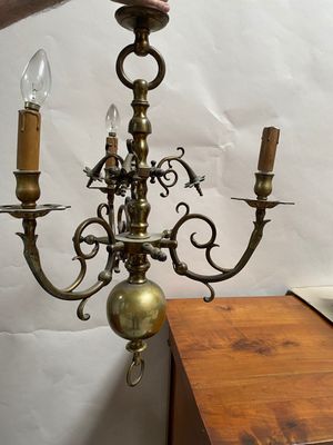 a person that is holding a chandelier in their hand