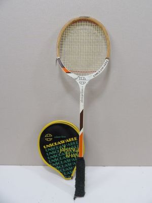 a tennis racket with a heart shaped tag attached to it