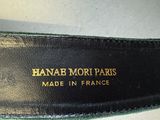 the bottom of a pair of black leather shoes with gold lettering