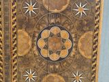 a wooden cabinet with a decorative design on it