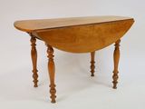 a small wooden table with a drop leaf on it