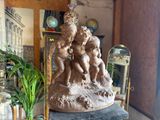a statue that is sitting on a table in a room