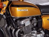 a yellow motorcycle parked in a garage with a black seat