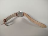 an image of a wrist watch with a leather band on a white surface
