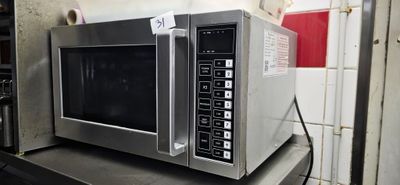 a microwave that is sitting on a shelf in a kitchen