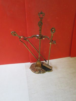 a metal sculpture of a man with a sword and a hat on a stand