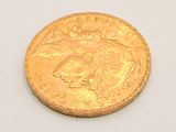 a gold coin with a picture of a woman on it