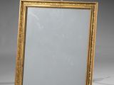 an antique gold framed mirror with a white background