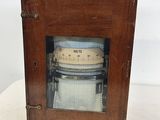 an old wooden box with a clock inside of it on a table