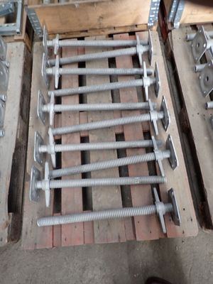 a pile of screws and bolts on a pallet in a warehouse