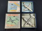 three boxed boxes of toy airplanes on a black surface
