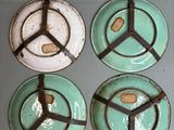 four plates with peace signs on them sitting on a table