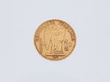 a close up of a gold coin on a white surface