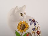 a white cat that is painted with flowers on it