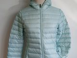 the jacket is light blue and has a hood that is attached to a mannequin