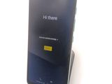 a cell phone that is sitting on top of a stand