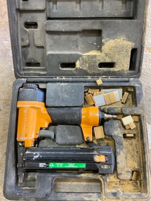 an image of a tool box with a stapler and a hammer in it
