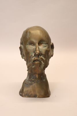 a bronze bust of a man with a beard