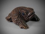 a close up of a figurine of a turtle on a gray surface