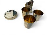 four cups sitting next to each other on a white surface