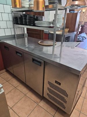 a kitchen with stainless steel counter tops and a dishwasher