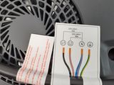 a black plastic basket with wires attached to it