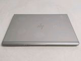 a laptop that is sitting on a white surface