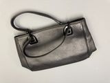 silver leather handbag on a white background