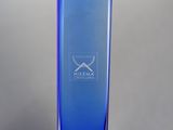 a blue glass vase with a white logo on it