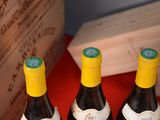 three bottles of wine sitting on a table next to a box