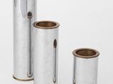 trois vases en argent munis d'anses et de poignées, sur fond blanc