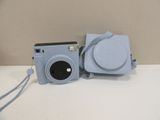 a blue camera sitting on top of a white table