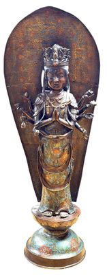 bronze statue of a woman with a crown on top of a vase
