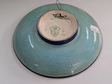 a blue bowl on a white table with a tag on it