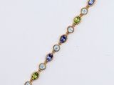 a yellow gold bracelet with multi colored stones