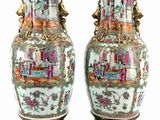 pair of oriental vases sitting on pedestal on a white surface