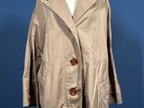 an image of a coat on a mannequin stand against a blue background
