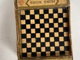 a small box with a checker board inside of it