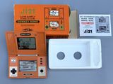 an orange gameboy sitting next to a white box